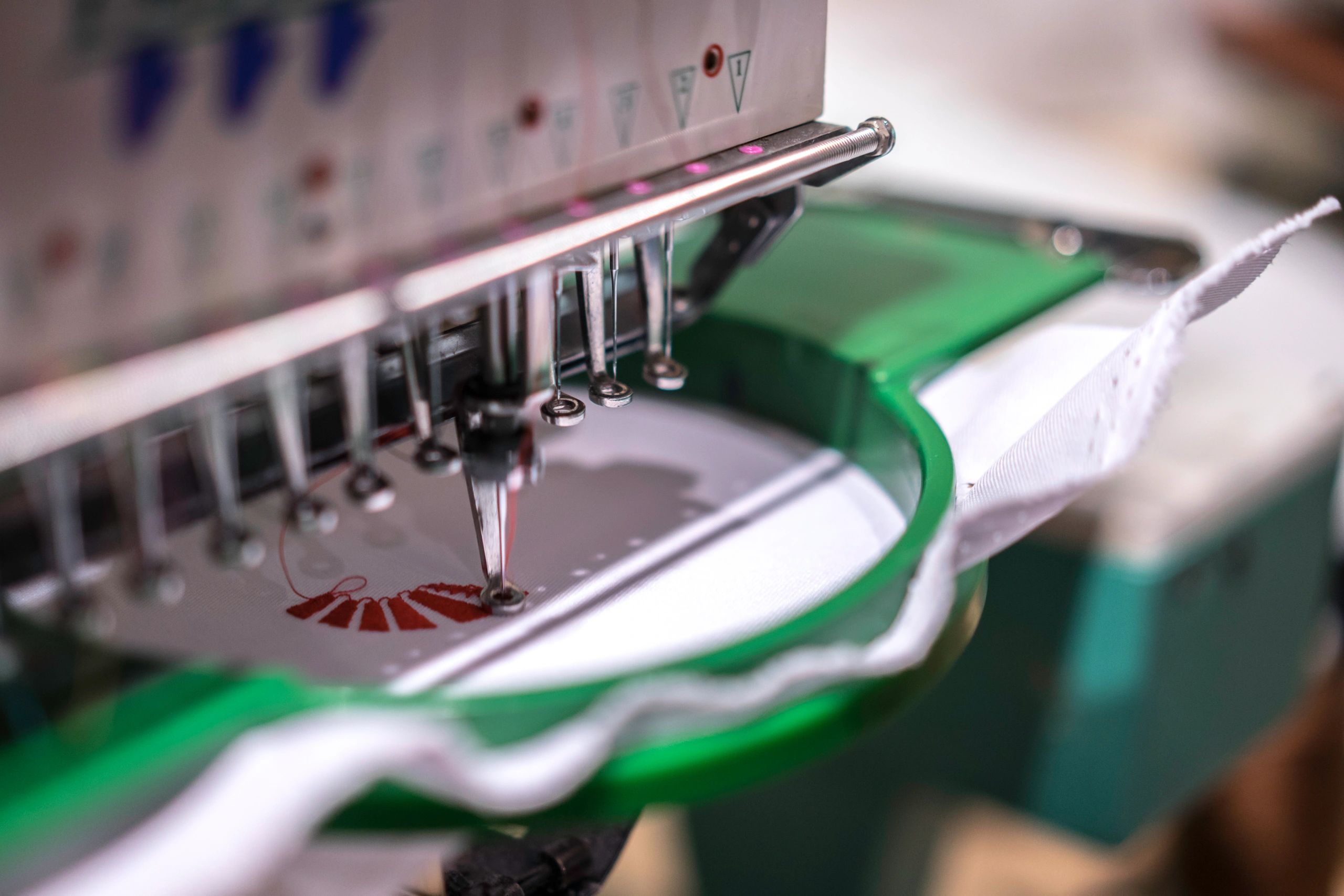 Industrial sewing machine representing custom branded apparel production