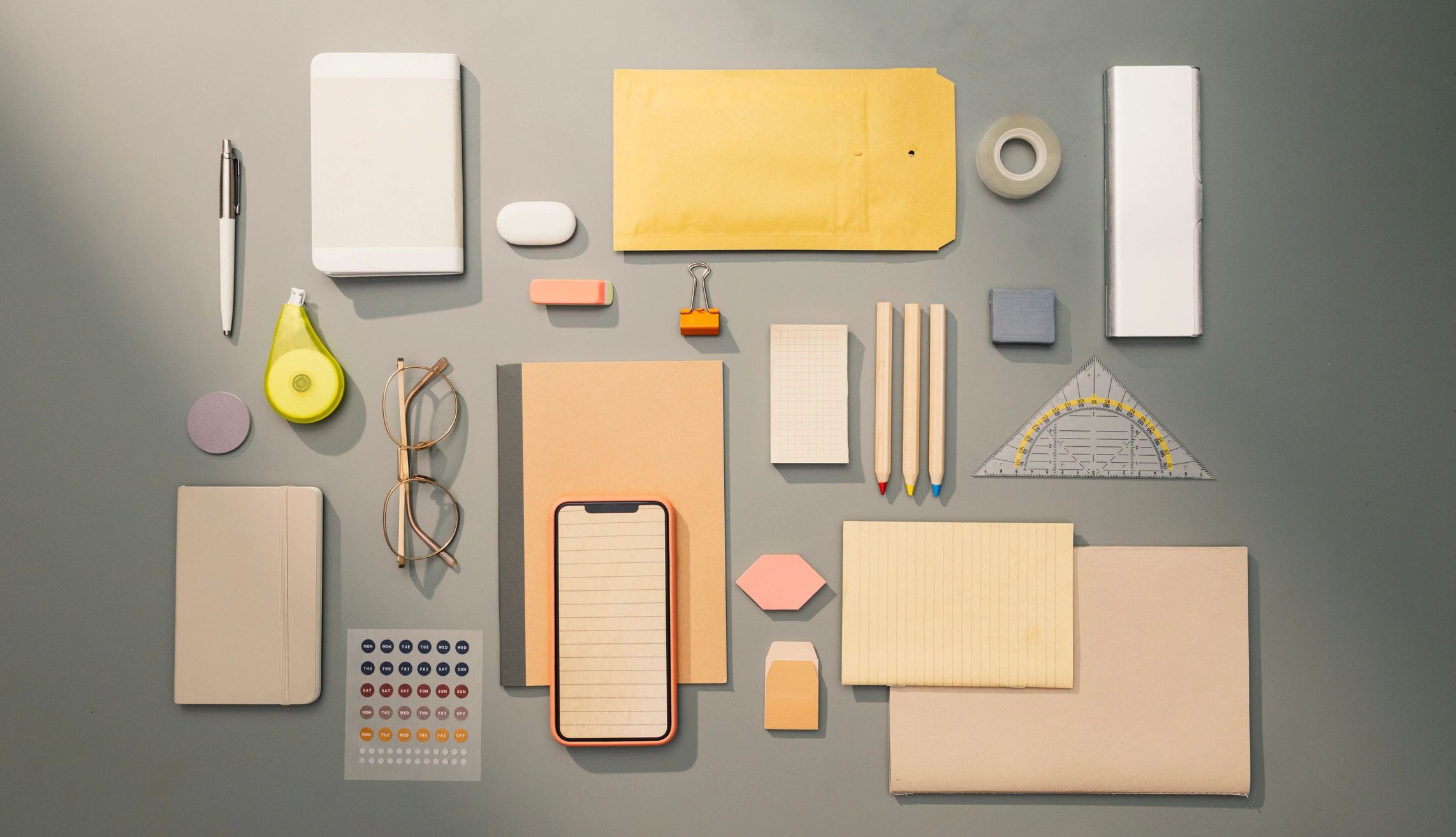 Flat lay of branded-style desk items and supplies
