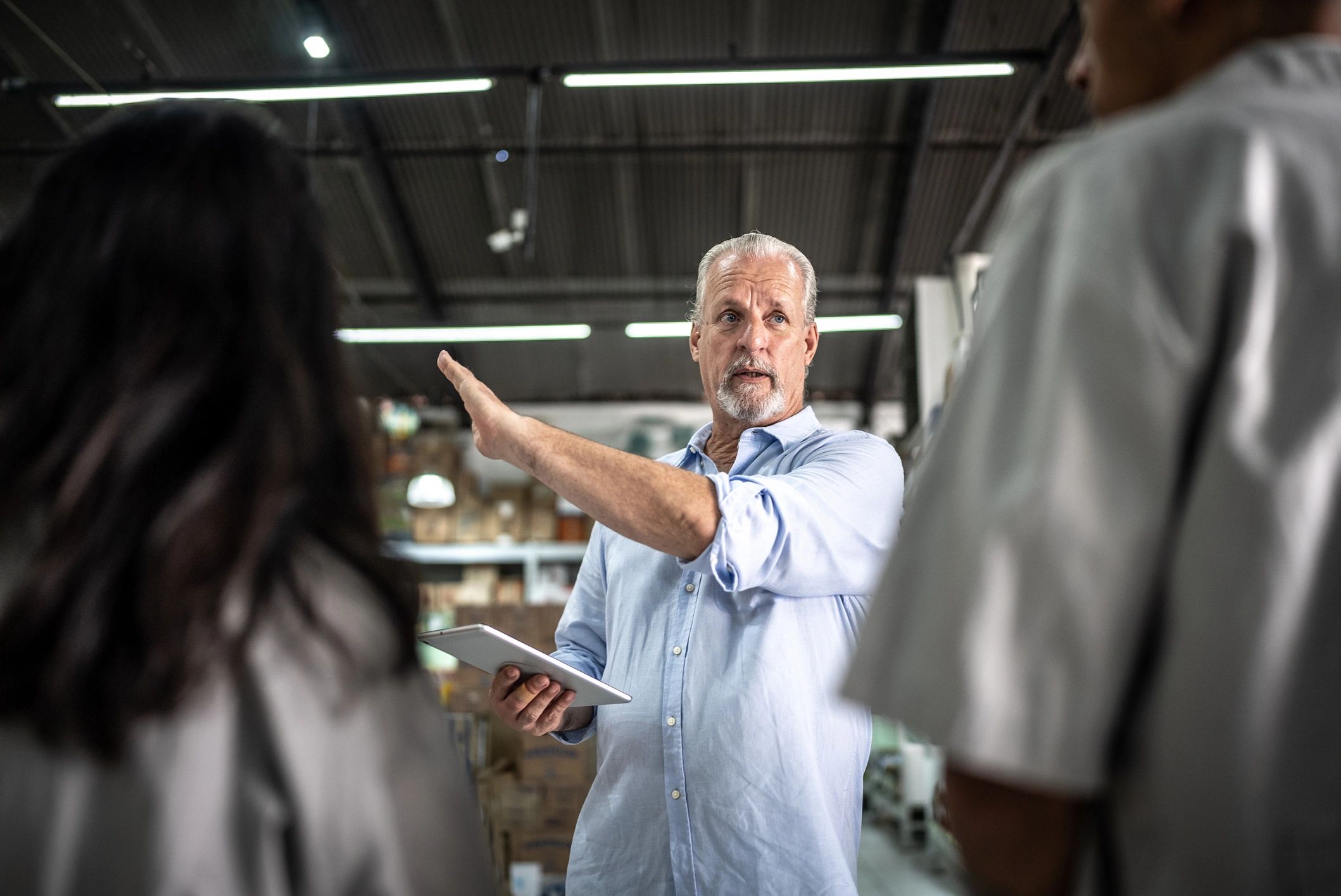 Manager speaking with employees in a workplace