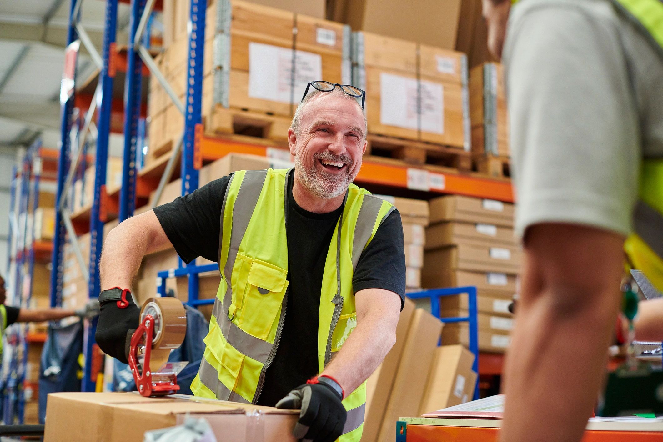 Warehouse team packing items representing fulfillment and project coordination