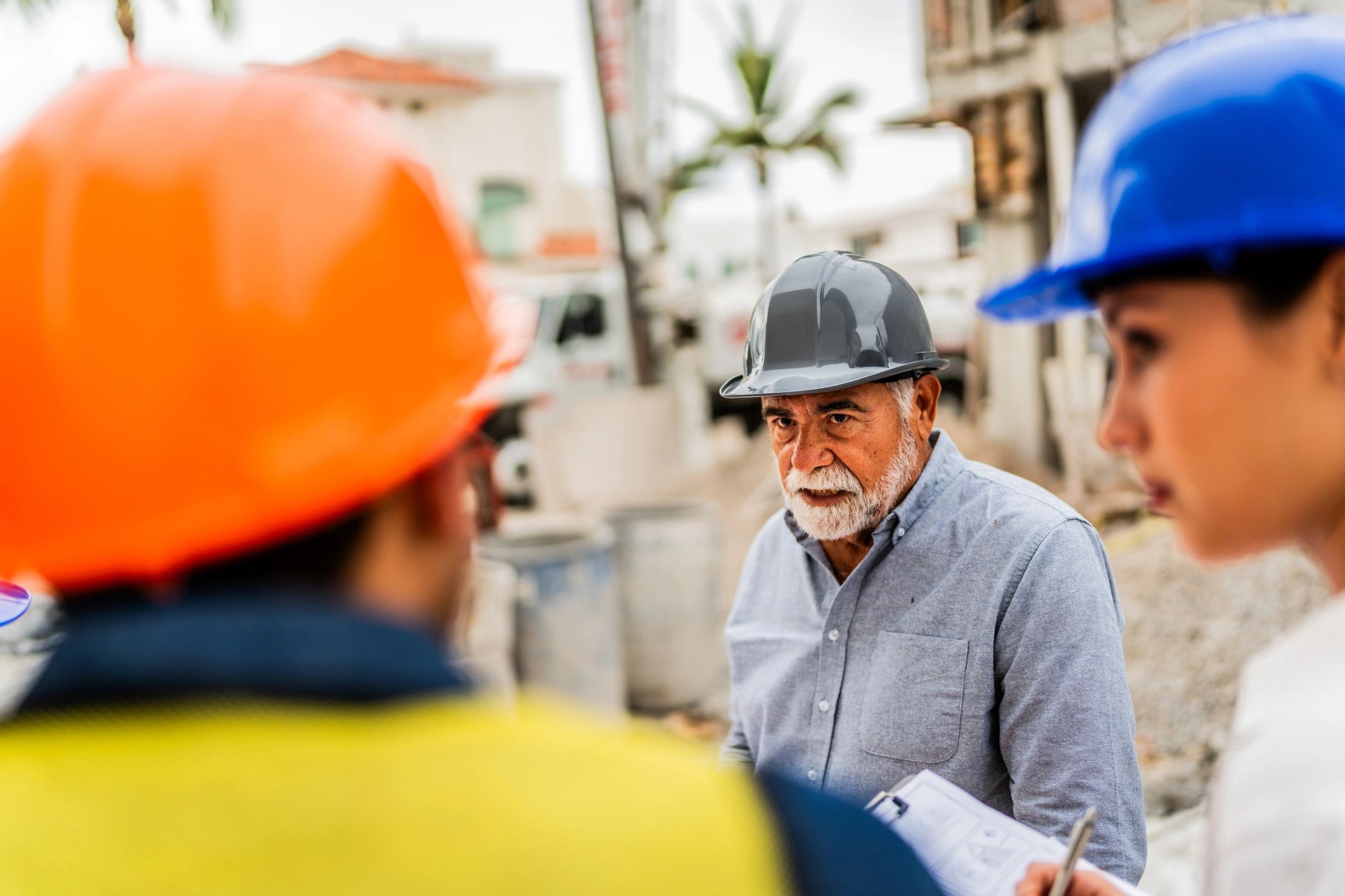Manager talking with employees on a construction site