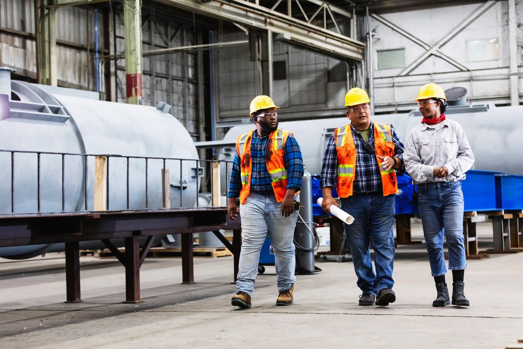 Workers in an industrial facility wearing workwear